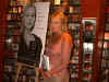 picture: Jewel posing by a blown up picture of her book cover.
